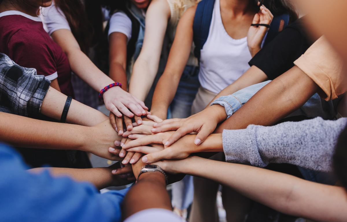 Hands of different people on top in the centre